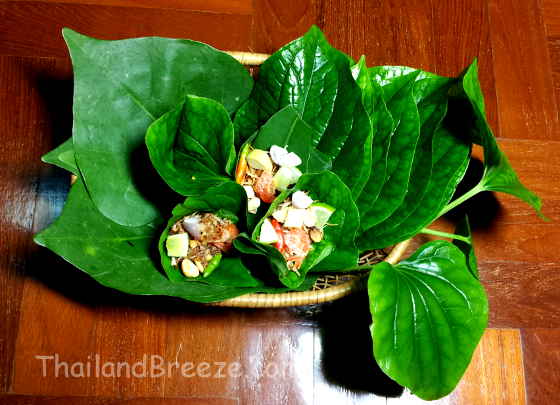 Miang kham is a traditional Thai snack that is wrapped in a leaf.