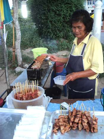 Sticky rice and grilled pork is common at night markets in Thailand